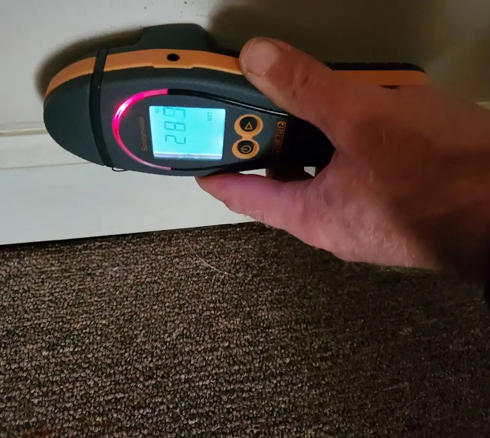 Moisture detection at baseboard during Storm Damage Restoration in Portsmouth